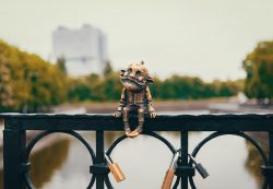 A bronze figure old man Homlin sits on the railing of the bridge